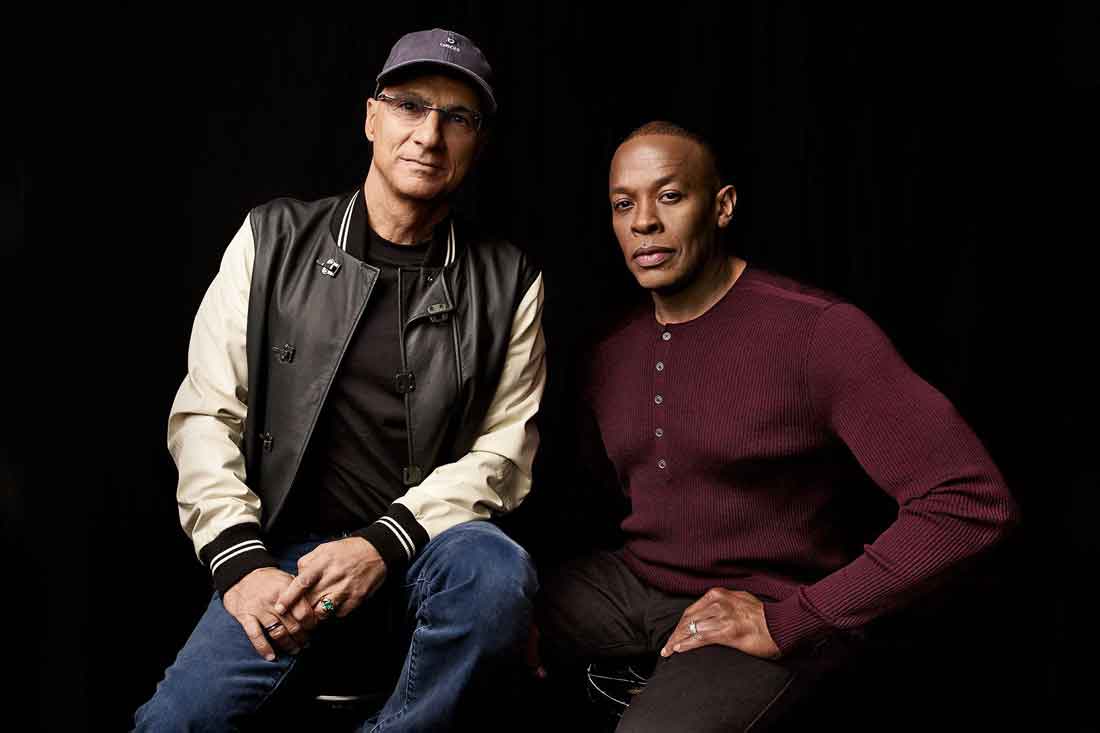 Jimmy Iovine in a baseball jacket and Dr. Dre in a maroon sweater.