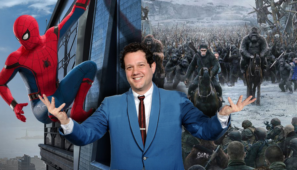 Michael Giacchino in a blue suit in front of images from Spider-Man Homecoming and War for the Planet of the Apes.