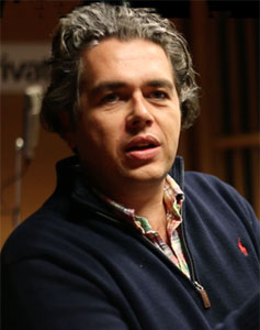 Lorne Balfe, his wavy gray hair swept back, in a navy blue Ralph Lauren Polo pullover with a plaid shirt beneath. 