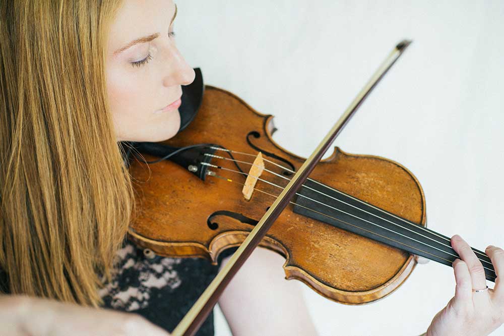 Close-up of Ronit Kirchman playing the violin.