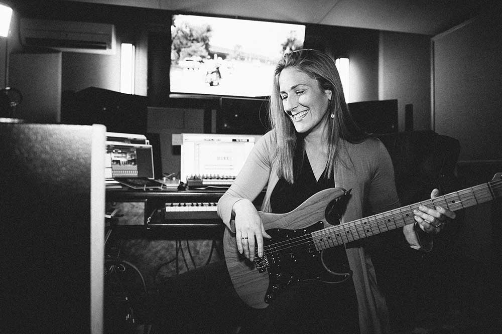 Ronit Kirchman plays guitar in her studio