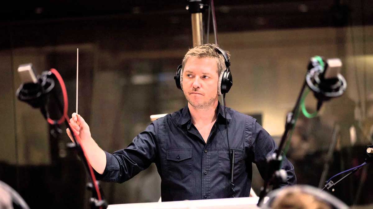 Atli Örvarsson conducts with headset on.