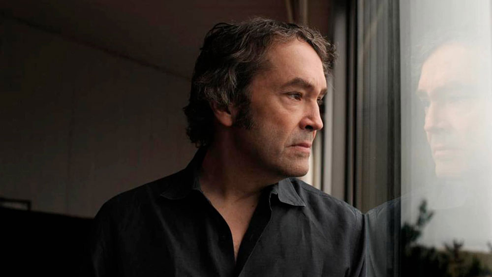 Carter Burwell reflects through a pane