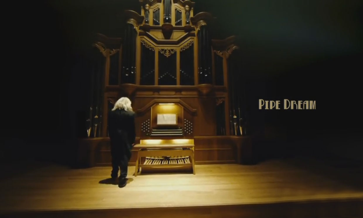 Man approaches pipe organ in the clip "Pipe Dream"