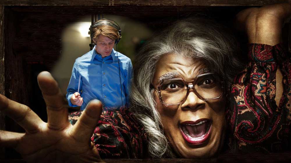 Composer Philip White conducts over Madea