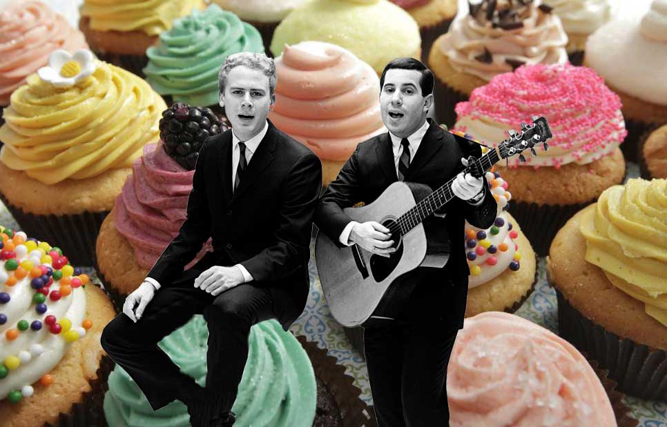 Art Garfunkel and Paul Simon amidst cupcakes.