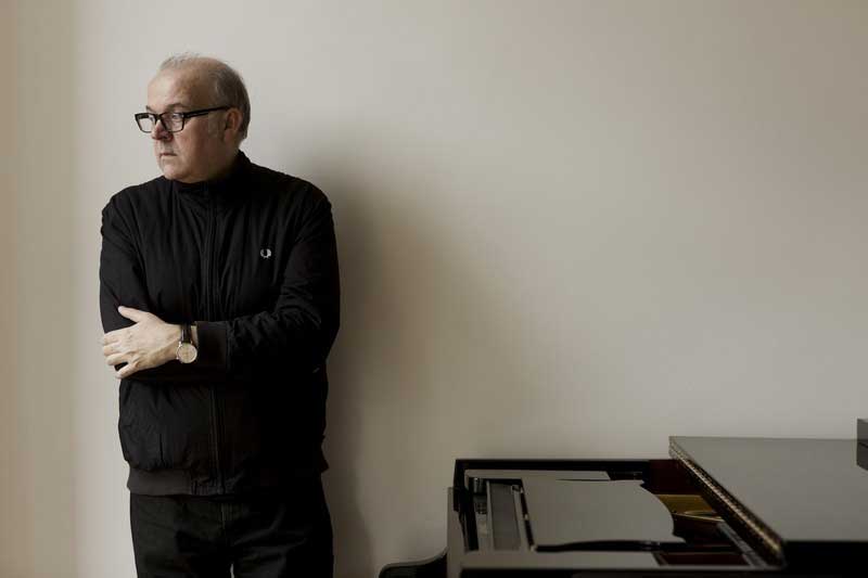 Composer Craig Armstrong stares pensively off camera. 