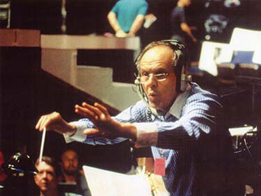 Elliot Lawrence conducts the Tonys wearing a headset.