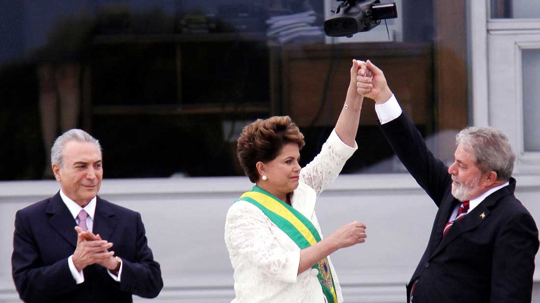 Brazil's political leaders raise their arms in victory on a public stage